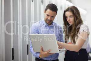 Two technicians looking at laptop