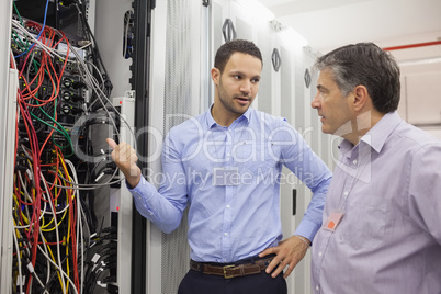 Two technicians discussing wiring
