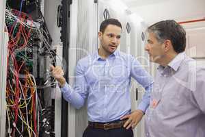 Two technicians discussing wiring