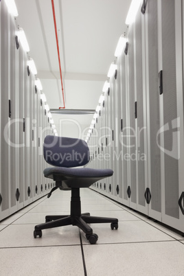 Chair in empty row of servers