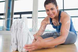Smiling woman stretching legs