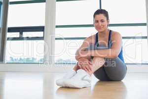 Smiling woman sitting on the floor