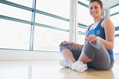 Woman sitting on floor and smiling