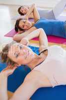 Smiling women doing sit ups