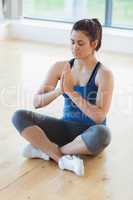 Woman sitting on the floor in yoga pose
