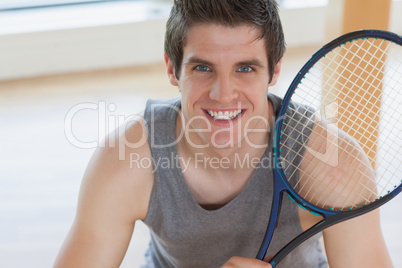 Happy man holding a tennis racket
