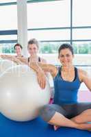 Women sitting with exercise balls