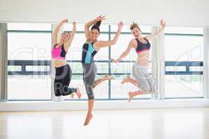 Women jumping in fitness studio