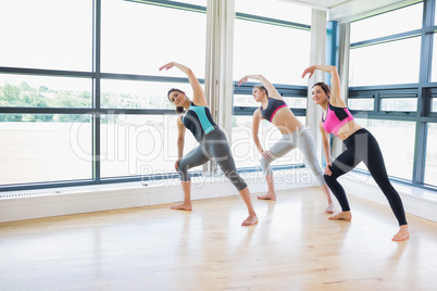 Women standing at the gym stretching