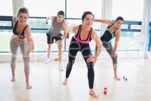 People in aerobics class lifting weights