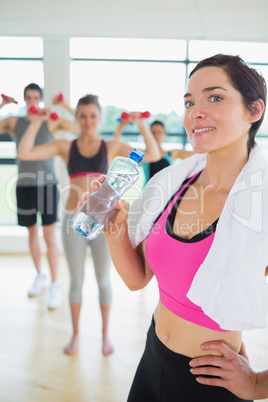 Woman drinking water at aerobics class