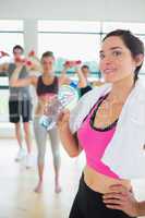 Woman drinking water at aerobics class