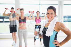 Woman at front of aerobics class