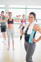 Smiling woman at front of aerobics class