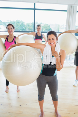 Women holding exercise balls