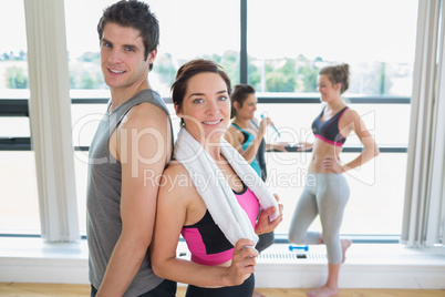 Man and woman standing back to back