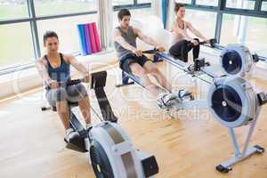 People using rowing machines