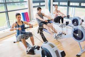 Three people on rowing machines