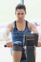 Focused woman at the rowing machine