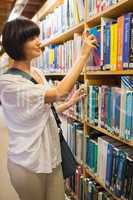 Woman choosing a book from the shelves