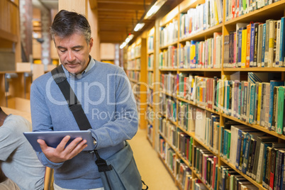 Man holding a tablet pc in a library