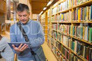 Man holding a tablet pc in a library