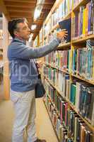 Man taking a book from the shelves