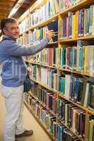 Man choosing book from shelf