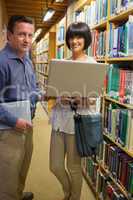 Man and woman holding laptop
