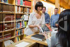 Woman taking out book