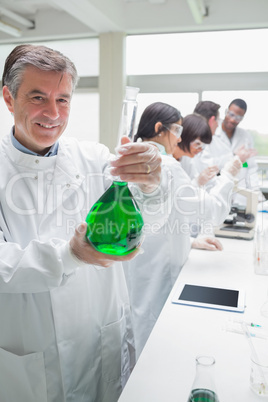 Chemist holding beaker