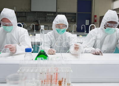 Chemists working in protective suits