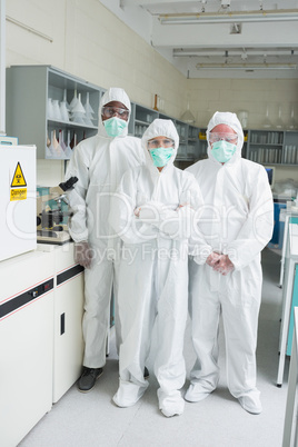Team of chemists in protective suits