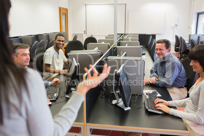 Teacher talking to group in computer room