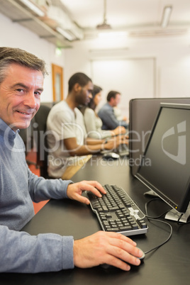 Smiling man working with the computer