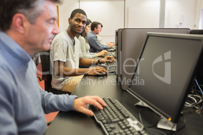 Man looking up from computer class