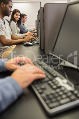 Smiling woman looking up from computer class