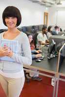 Teacher holding tablet pc in computer class