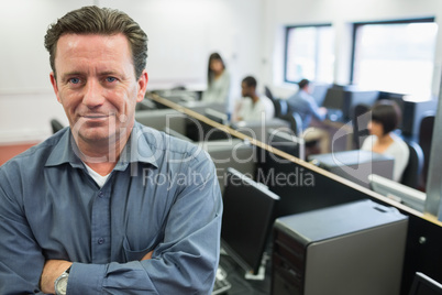 Man smiling at front of computer class