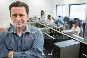 Man smiling at front of computer class