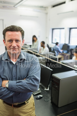 Man with crossed arms in computer class