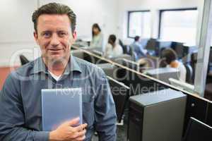 Man holding a tablet pc in computer room