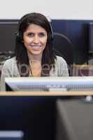 Smiling woman working in computer room