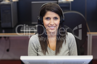Woman happily working in computer room