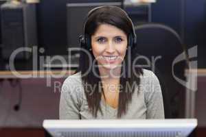 Woman happily working in computer room
