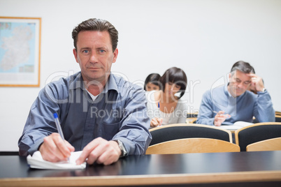Man looking up from class