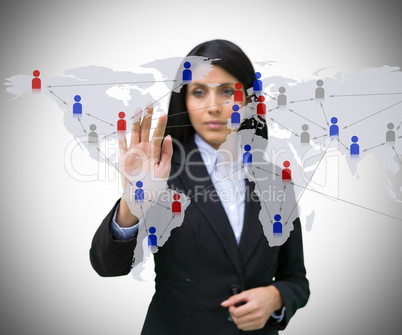 Businesswoman touching world map interface