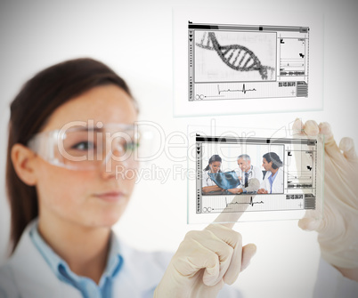 Lab technician selecting medical image from hologram interface