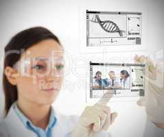 Lab technician selecting medical image from hologram interface