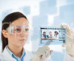Woman pointing on picture of doctor and nurses loking at x ray o